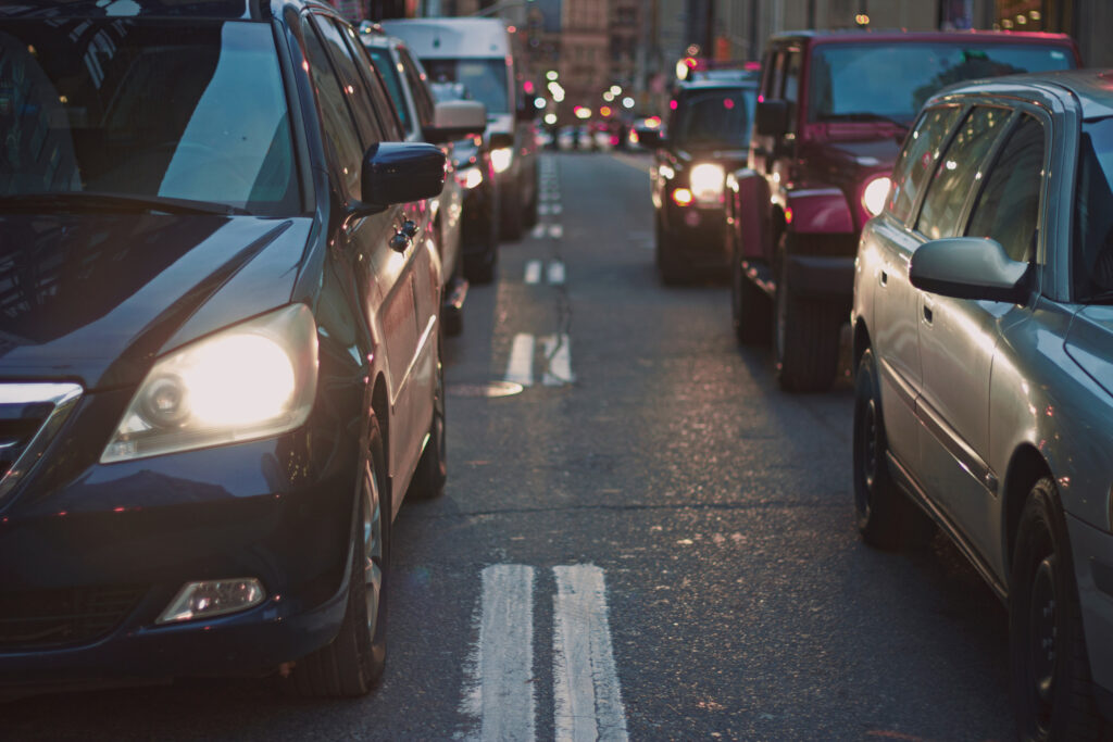 Vehicles in bumper to bumper traffic on a busy road
